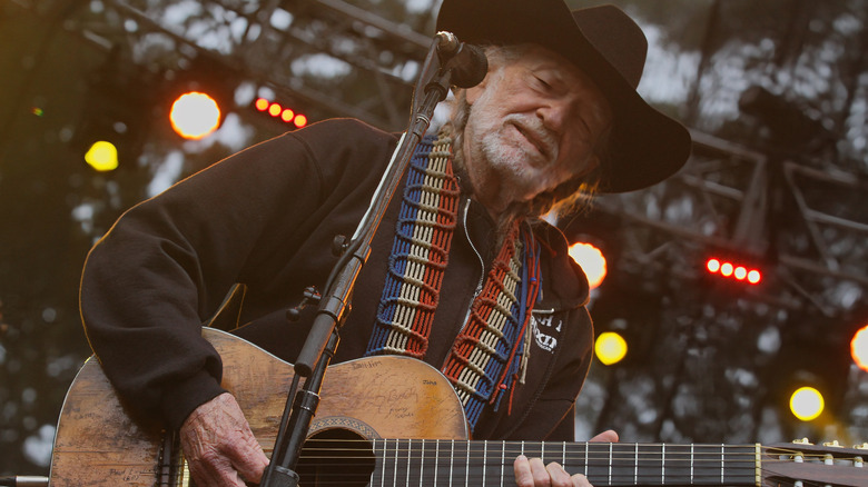 Willie Nelson performing on stage.