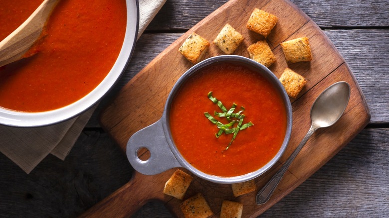 Tomato soup served with herbs and croutons
