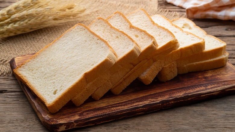 sliced white bread on wooden board