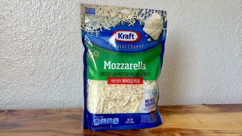 A bag of Kraft Whole Milk Shredded Mozzarella Cheese on a wooden table
