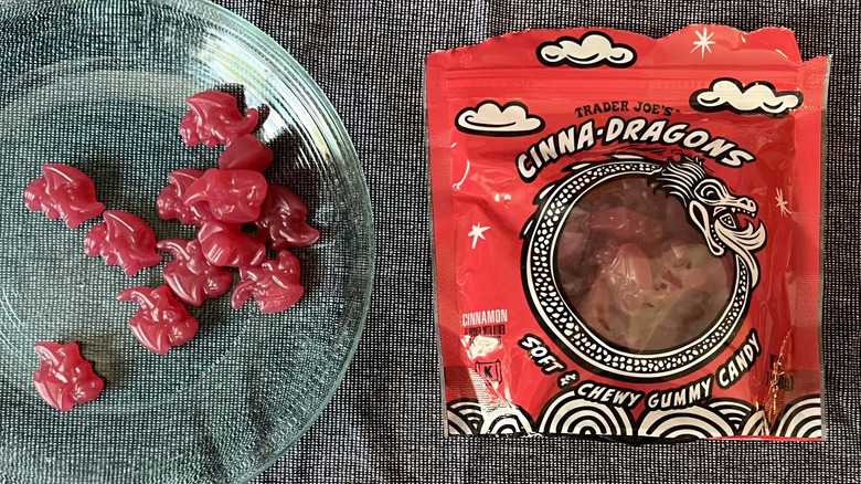 A handful of Trader Joe's Cinna-Dragons on a glass plate next to a bag of Cinna-Dragons