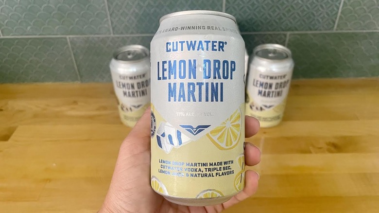 Hand holding a can of Cutwater's Lemon Drop Martini cocktail