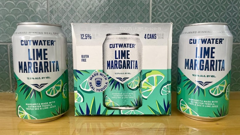 A box and two cans of Cutwater Lime Margarita cocktails