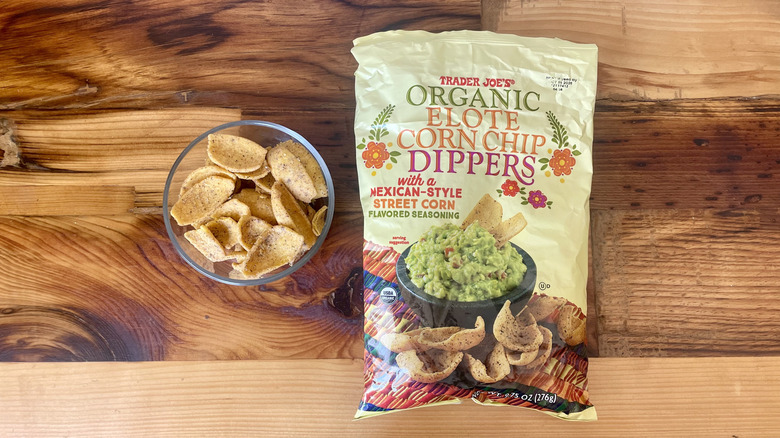 Overhead view of a a bag and dish of Organic Elote Corn Chip Dippers on a wooden table top