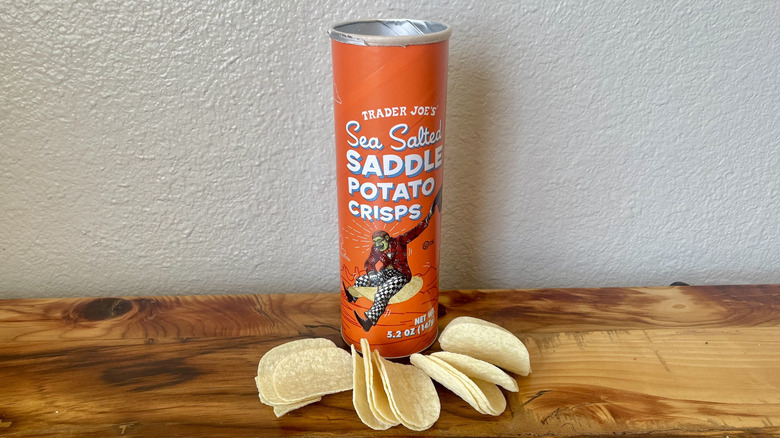 A canister of Sea Salted Saddle Potato Chip Crisps on a wooden table top