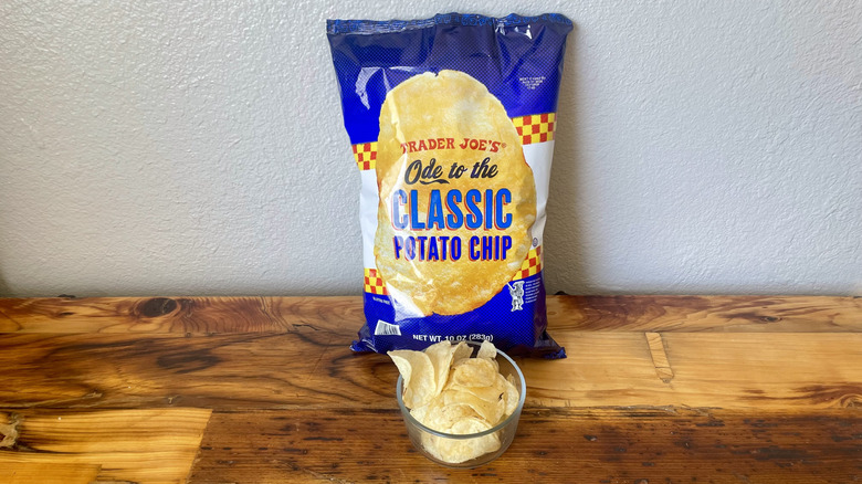 A bag and dish of Ode To The Classic Potato Chips on a wooden table top