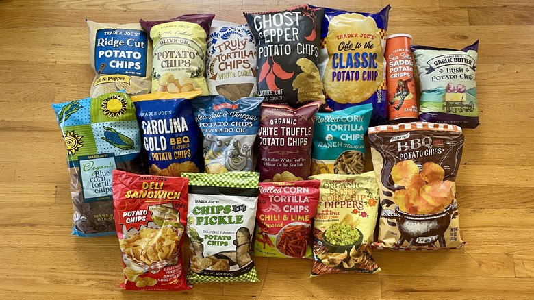 Collection of Trader Joe's chips spread out on a wooden background