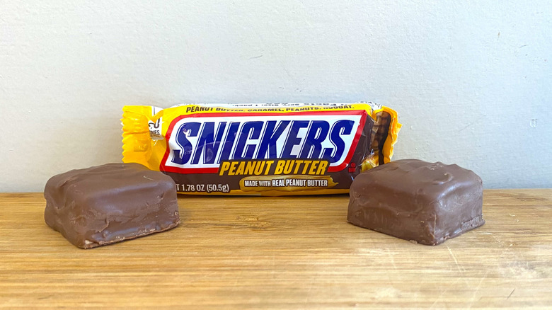 Wrapped Snickers Peanut Butter bar with two Snickers Peanut Butter squares on either side