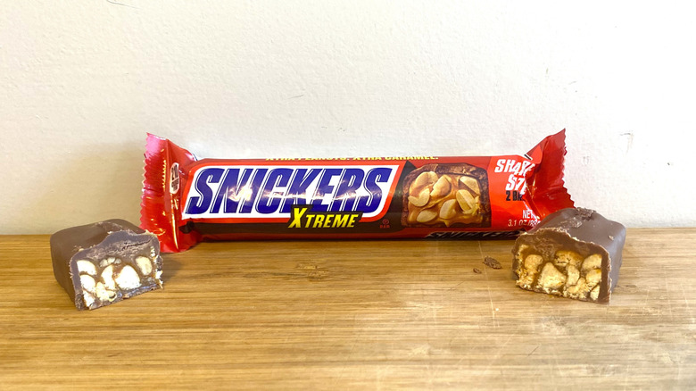 Wrapped Snickers Xtreme bar with a halved Snickers Xtreme bar on either side