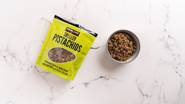 bag and a bowl of pistachios