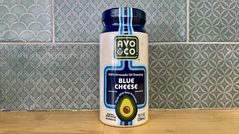 Bottle of Avo & Co. Blue Cheese Dressing on wooden countertop