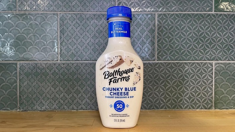 Bottle of Bolthouse Farms Chunky Blue Cheese Dressing on wooden countertop