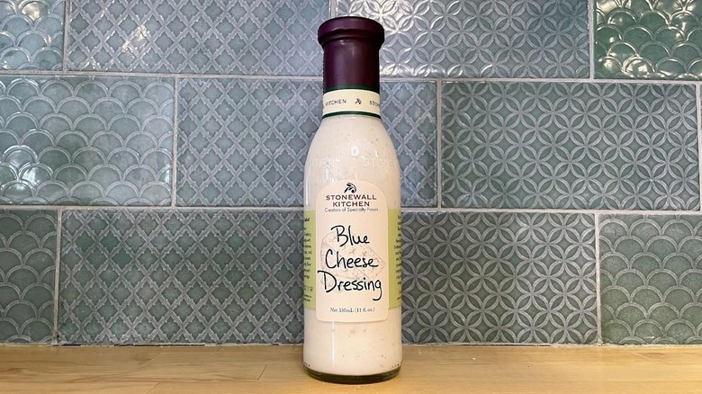 Bottle of Stonewall Kitchen Blue Cheese Dressing on wooden countertop