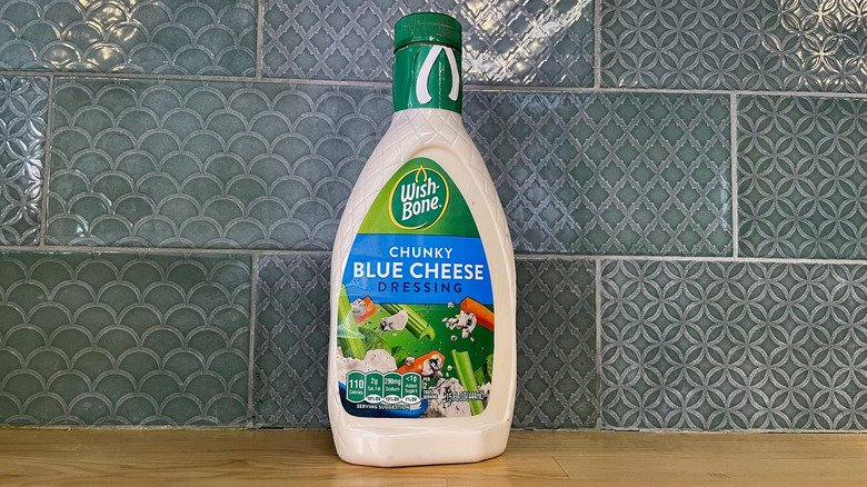 Bottle of Wish-Bone Chunky Blue Cheese Dressing on wooden countertop