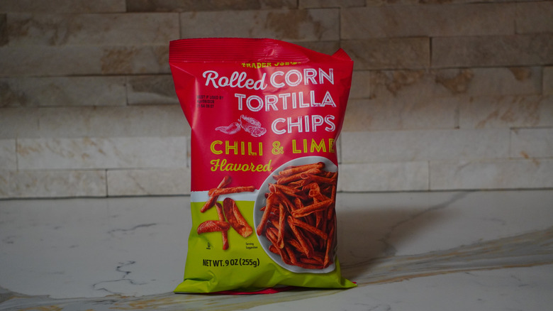Bag of Trader Joe's Chili & Lime Flavored Rolled Corn Tortilla Chips on marble countertop