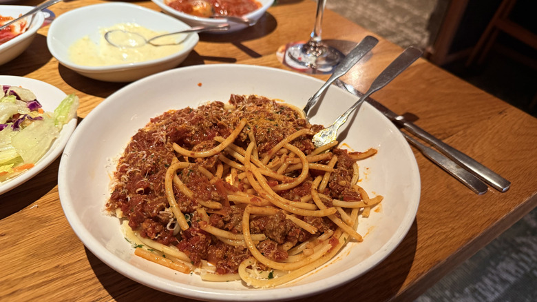 Bowl of eaten Spicy Three Meat Sauce on bucatini