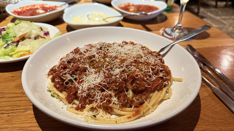 bowl of spicy three meat sauce on bucatini