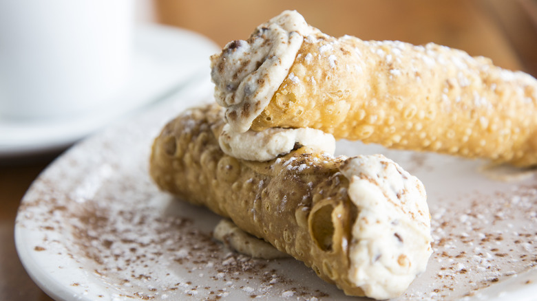 2 cannolis on a plate