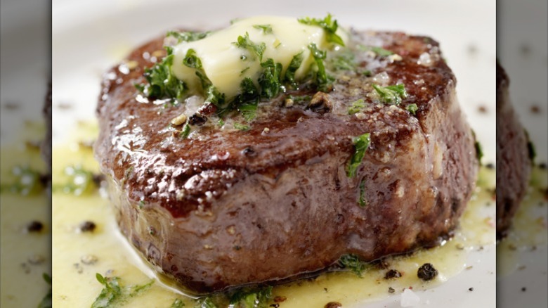 A medium-rare filet mignon with compound butter
