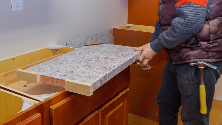 Contractor installing laminate kitchen countertop