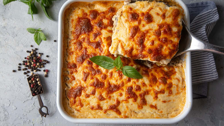 A spatula lifts a casserole slice.