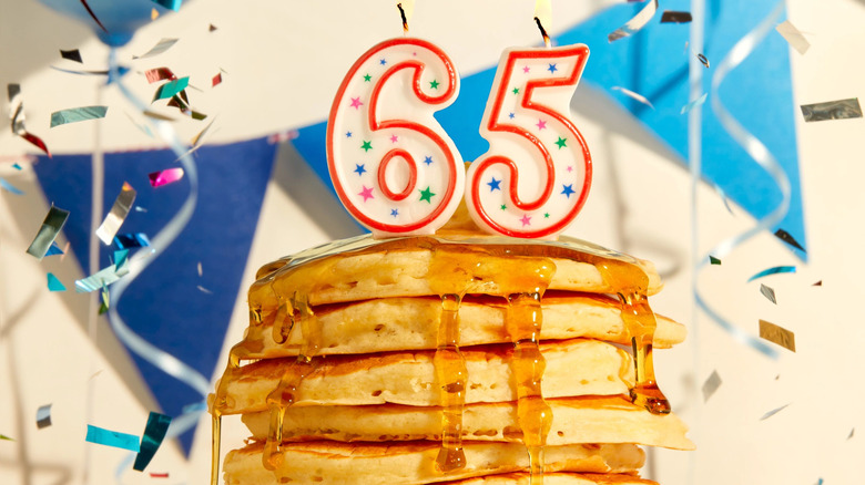 65 birthday candle on top of pancake snack