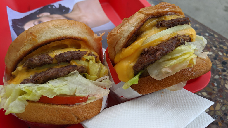 Two In'N'Out double doubles, animal style with extra spread and grilled onions, sit in the company's iconic red tray