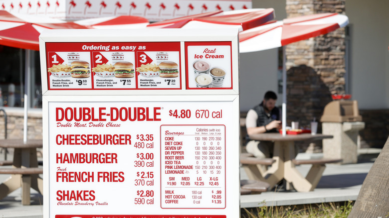 A sign for the In-N-Out menu at a restaurant location in California
