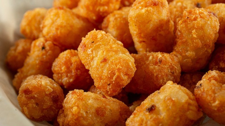 Cooked tater tots in a basket
