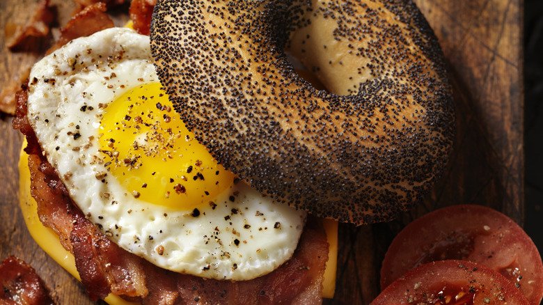 bacon, egg, and cheese sesame bagel cut in half