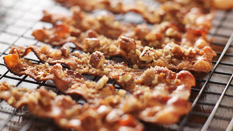 Strips of candied bacon with sugar and chopped nuts.