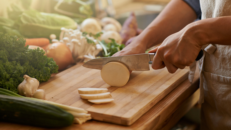 Hands chopping vegetables