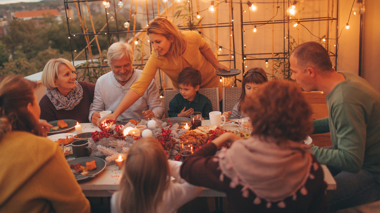 family dinner with warm string lights