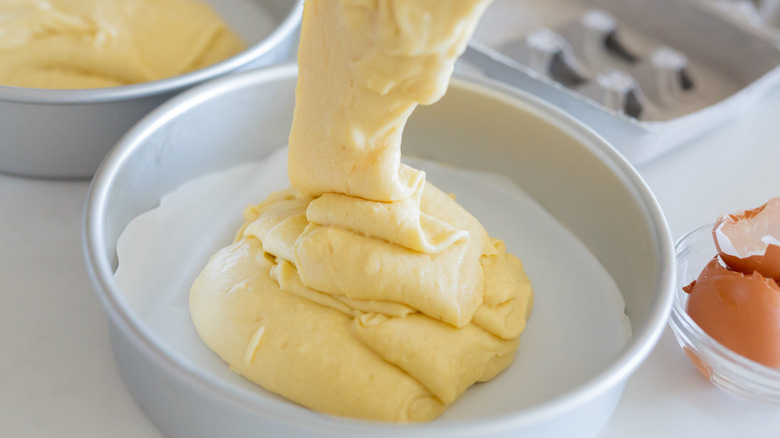Pouring batter into a cake pan