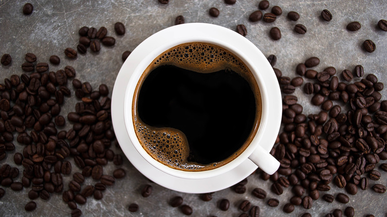 coffee in white cup with coffee beans