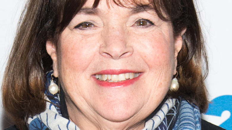 Ina Garten with wide smile and pearl earrings