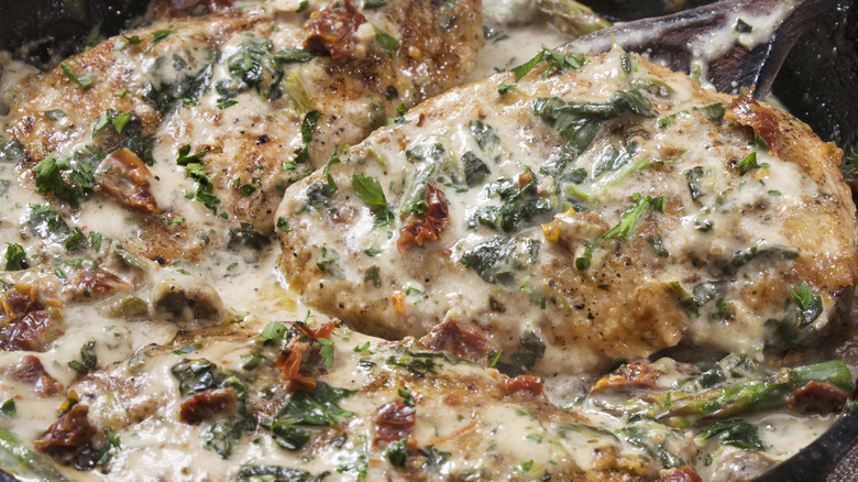 backed chicken with cream sauce in cast iron skillet