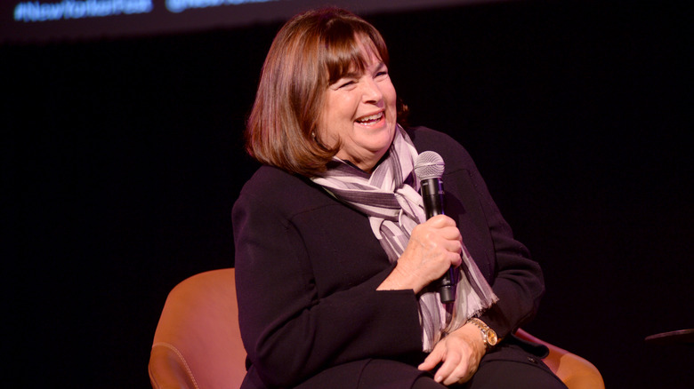 Ina Garten laughing with a microphone
