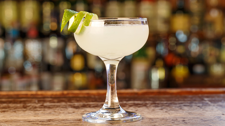 Daiquiri cocktail in glass with lime twist