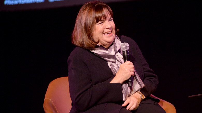 Ina Garten smiling holding a microphone