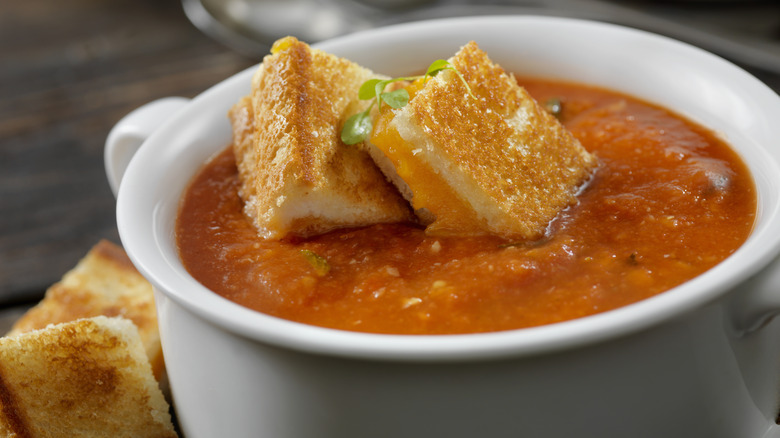 bowl with tomato soup and grilled cheese croutons