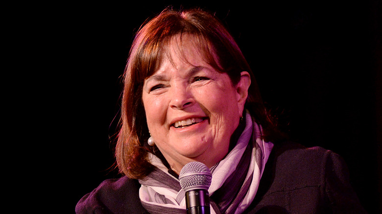 Ina Garten smiling on stage with microphone