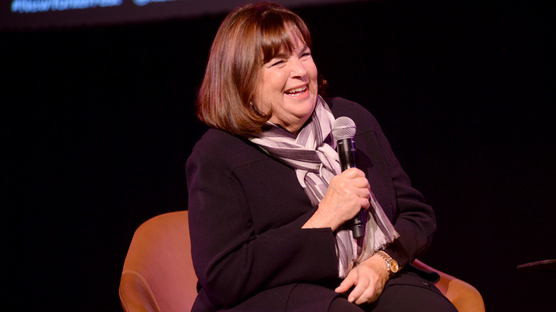 Ina Garten smiling holding microphone