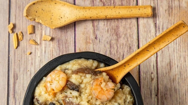 A bowl of risotto with an edible spoon