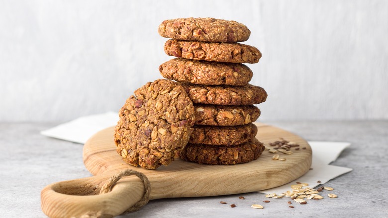 stack of oatmeal cookies on a round wooden board