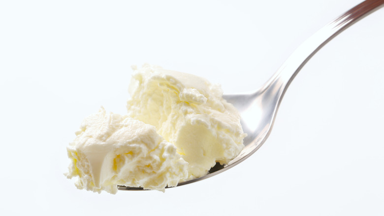 Metal spoon of cream cheese