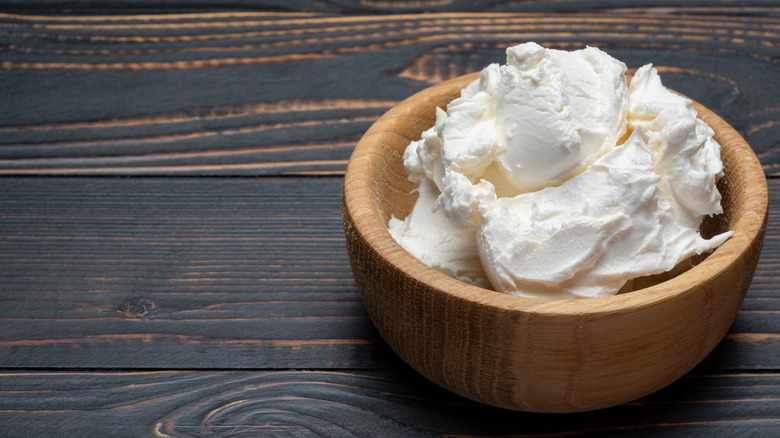 Mascarpone cheese in wooden bowl