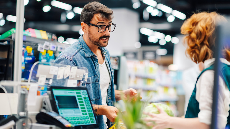 A customer complaining to a supermarket employee.