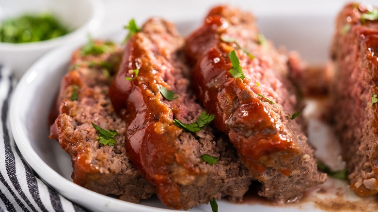 sliced meatloaf on a white serving plate