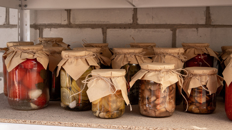 jars of various homemade pickles on a shelf